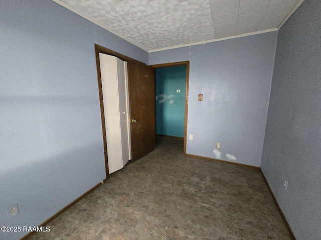 empty room with baseboards and crown molding