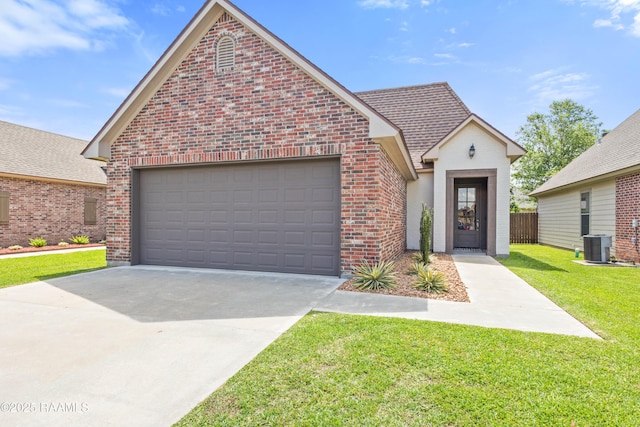 113 Gilmore Rd, Youngsville, LA 70592 - view of front of property with brick siding, driveway, an attached garage, central AC unit, and a shingled roof
