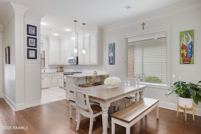 107 Harbor Walk Dr, Lafayette, LA 70508 - dining space with baseboards, light wood-style floors, crown molding, and recessed lighting
