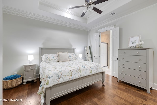 107 Harbor Walk Dr, Lafayette, LA 70508 - bedroom featuring a tray ceiling, dark wood-style floors, ornamental molding, and ceiling fan