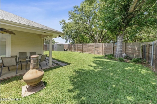 211 Dartmoor Dr, Lafayette, LA 70506 - view of yard featuring a storage unit, an outdoor structure, a patio, and a ceiling fan