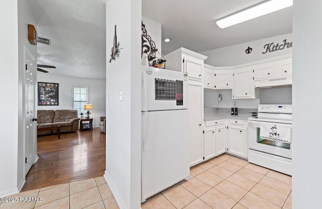 211 Dartmoor Dr, Lafayette, LA 70506 - kitchen featuring white appliances, under cabinet range hood, light tile patterned floors, white cabinetry, and light countertops