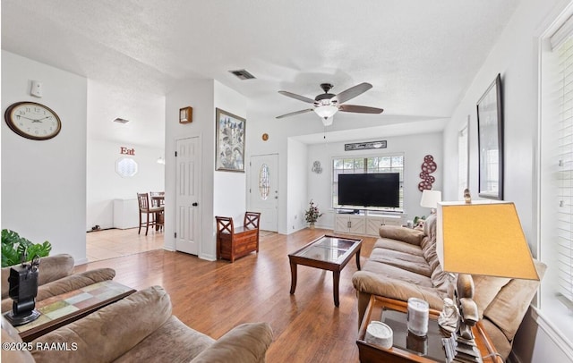 211 Dartmoor Dr, Lafayette, LA 70506 - living room with a ceiling fan, wood finished floors, vaulted ceiling, and a textured ceiling