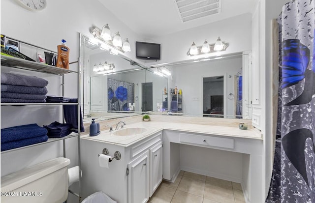 211 Dartmoor Dr, Lafayette, LA 70506 - bathroom featuring tile patterned floors, toilet, and vanity