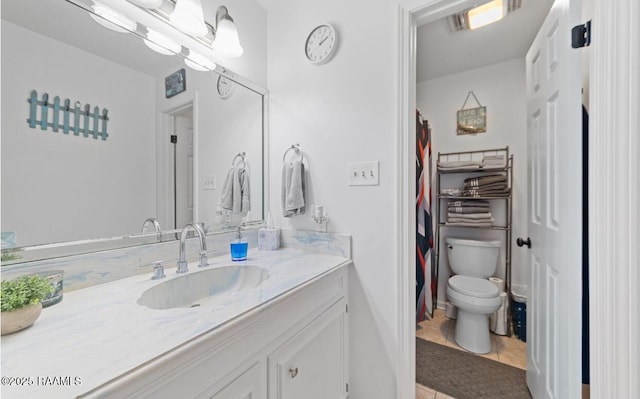 211 Dartmoor Dr, Lafayette, LA 70506 - bathroom featuring toilet, vanity, and tile patterned flooring