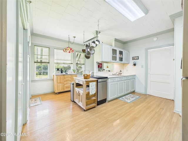 1635 Myrtle Pl, Lafayette, LA 70506 - kitchen featuring crown molding, light wood-type flooring, glass insert cabinets, light countertops, and stainless steel dishwasher