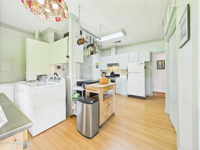 1635 Myrtle Pl, Lafayette, LA 70506 - kitchen featuring freestanding refrigerator, washing machine and dryer, crown molding, light wood-style flooring, and under cabinet range hood