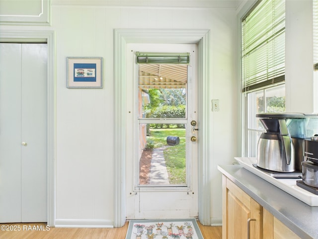 1635 Myrtle Pl, Lafayette, LA 70506 - doorway to outside with light wood-type flooring, plenty of natural light, and baseboards
