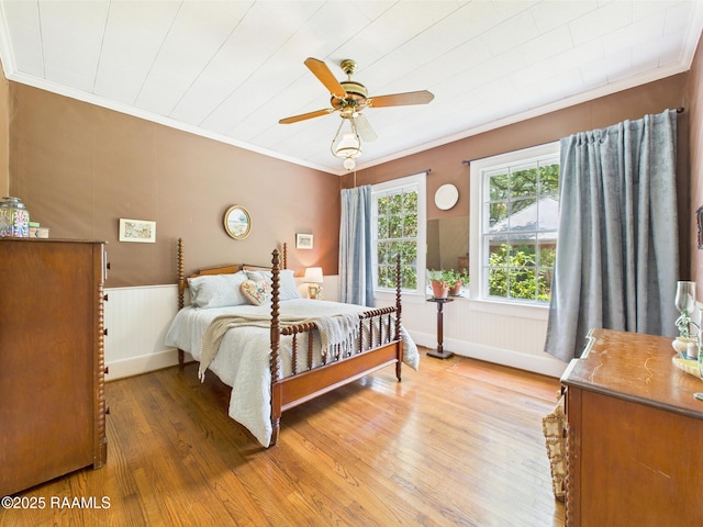 1635 Myrtle Pl, Lafayette, LA 70506 - bedroom featuring crown molding, light wood-style flooring, wainscoting, and ceiling fan