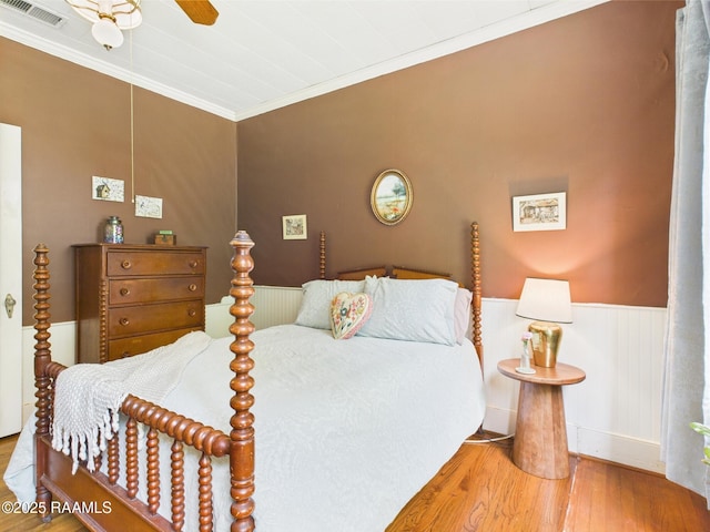 1635 Myrtle Pl, Lafayette, LA 70506 - bedroom featuring wood finished floors, crown molding, wainscoting, and a ceiling fan