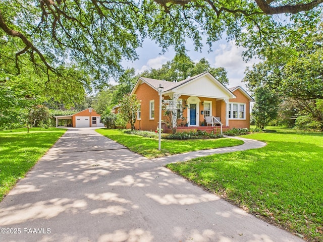 1635 Myrtle Pl, Lafayette, LA 70506 - view of front of house with covered porch, an outdoor structure, a front lawn, and a detached garage