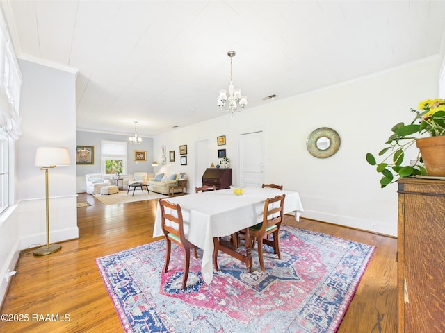 1635 Myrtle Pl, Lafayette, LA 70506 - dining room featuring a chandelier, crown molding, light wood-type flooring, and baseboards