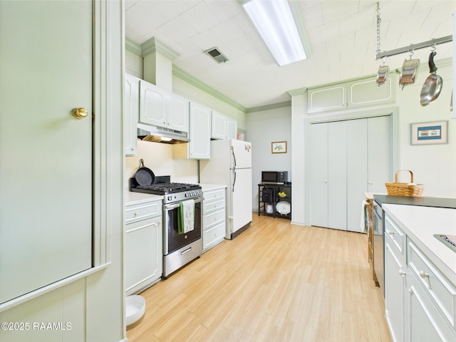 1635 Myrtle Pl, Lafayette, LA 70506 - kitchen featuring gas range, under cabinet range hood, freestanding refrigerator, ornamental molding, and light countertops