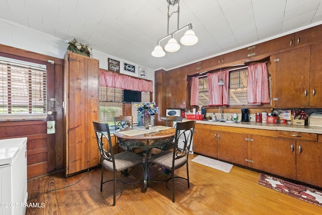 408 Loraine St, Abbeville, LA 70510 - dining room with light wood-style flooring, plenty of natural light, wooden walls, and ornamental molding