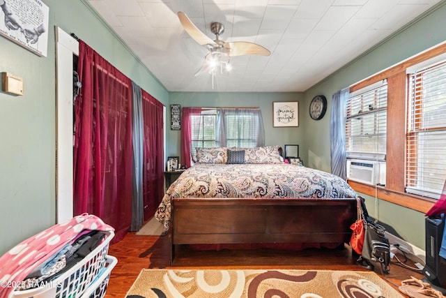 408 Loraine St, Abbeville, LA 70510 - bedroom featuring wood finished floors, multiple windows, cooling unit, and ceiling fan