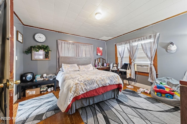 408 Loraine St, Abbeville, LA 70510 - bedroom with wood finished floors, ornamental molding, cooling unit, and baseboards