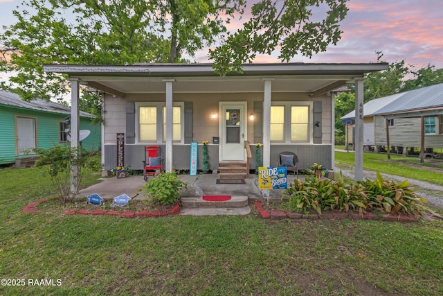 408 Loraine St, Abbeville, LA 70510 - view of front facade with covered porch and a front lawn