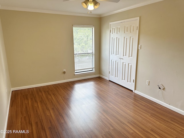 701 S College Rd Unit 208, Lafayette, LA 70503 - unfurnished bedroom with baseboards, dark wood-type flooring, a closet, crown molding, and a ceiling fan
