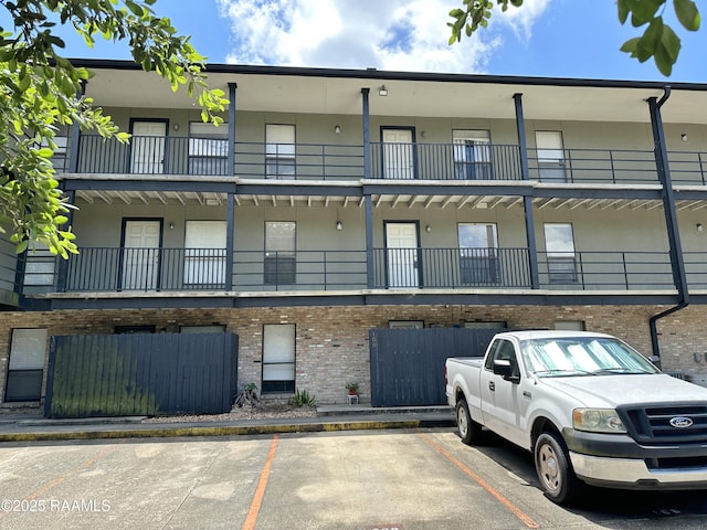 701 S College Rd Unit 208, Lafayette, LA 70503 - view of building exterior with uncovered parking