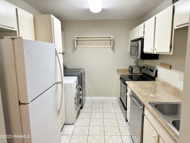 701 S College Rd Unit 208, Lafayette, LA 70503 - kitchen featuring stainless steel appliances, independent washer and dryer, a sink, light countertops, and white cabinetry