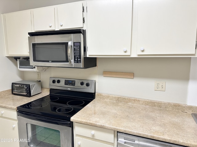 701 S College Rd Unit 208, Lafayette, LA 70503 - kitchen with stainless steel appliances, white cabinets, and light countertops