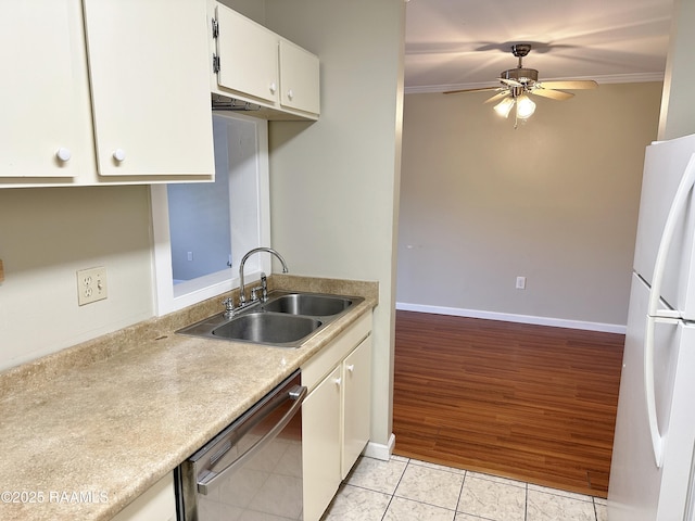701 S College Rd Unit 208, Lafayette, LA 70503 - kitchen featuring a sink, freestanding refrigerator, stainless steel dishwasher, ceiling fan, and white cabinets