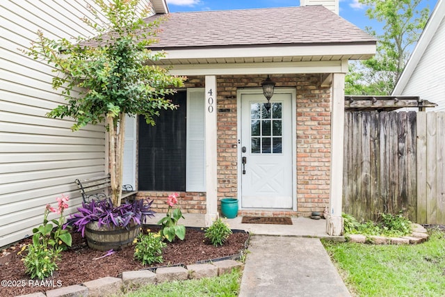 400 Mustang St, Lafayette, LA 70506 - entrance to property featuring a chimney, roof with shingles, and brick siding