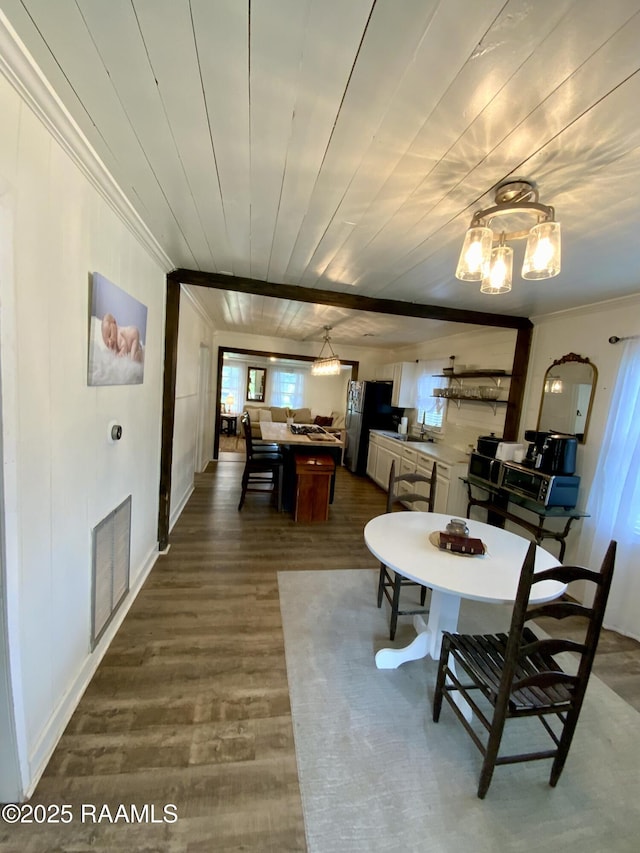 808 6th St, Rayne, LA 70578 - dining space with ornamental molding, dark wood-style floors, and a chandelier