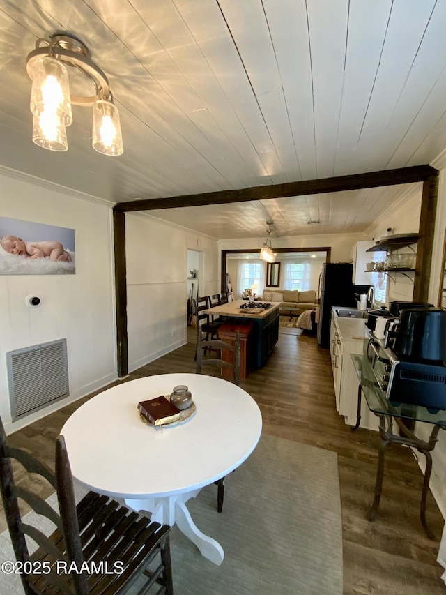 808 6th St, Rayne, LA 70578 - dining area featuring dark wood-type flooring, ornamental molding, and wooden ceiling