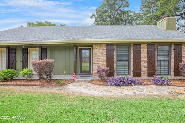 116 Twin Lakes Dr, Youngsville, LA 70592 - ranch-style home featuring a chimney, a shingled roof, a front yard, and brick siding