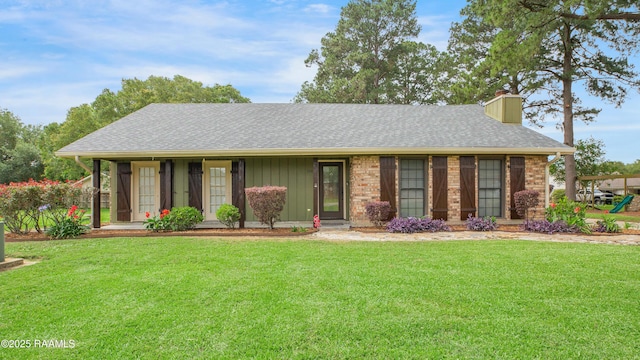 116 Twin Lakes Dr, Youngsville, LA 70592 - ranch-style house with a chimney, a front lawn, roof with shingles, and board and batten siding