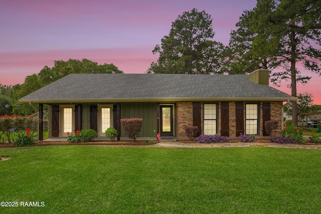 116 Twin Lakes Dr, Youngsville, LA 70592 - ranch-style house featuring a front yard, a chimney, a shingled roof, and board and batten siding