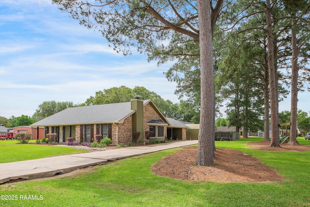 116 Twin Lakes Dr, Youngsville, LA 70592 - view of front of home featuring a chimney, brick siding, curved driveway, and a front yard