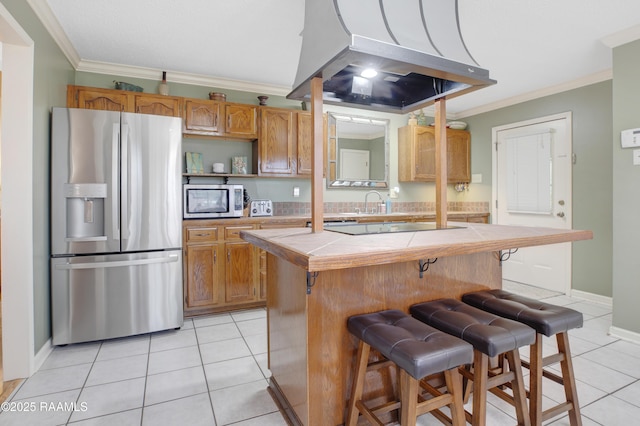 116 Twin Lakes Dr, Youngsville, LA 70592 - kitchen with stainless steel appliances, tile counters, crown molding, extractor fan, and light tile patterned floors