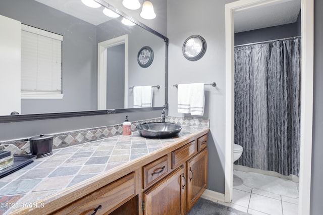 116 Twin Lakes Dr, Youngsville, LA 70592 - full bathroom featuring toilet, vanity, tile patterned floors, and a shower with shower curtain