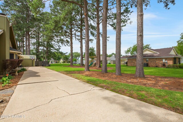 116 Twin Lakes Dr, Youngsville, LA 70592 - view of grassy yard with a residential view and concrete driveway