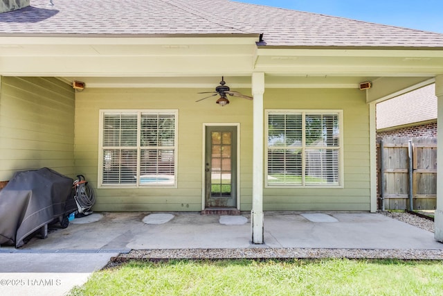 103 Barronne St, Lafayette, LA 70503 - doorway to property featuring roof with shingles, ceiling fan, and a patio