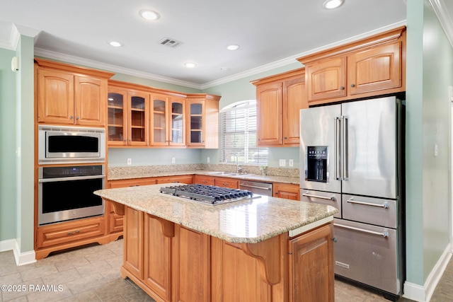 103 Barronne St, Lafayette, LA 70503 - kitchen with stainless steel appliances, a sink, ornamental molding, a kitchen island, and light stone countertops