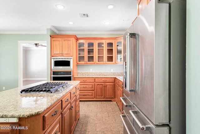 103 Barronne St, Lafayette, LA 70503 - kitchen with stainless steel appliances, ornamental molding, glass insert cabinets, light stone countertops, and a center island