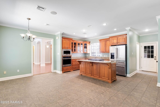 103 Barronne St, Lafayette, LA 70503 - kitchen featuring appliances with stainless steel finishes, a chandelier, baseboards, a center island, and glass insert cabinets