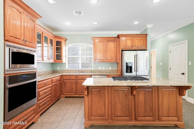 103 Barronne St, Lafayette, LA 70503 - kitchen featuring stainless steel appliances, a sink, a kitchen island, crown molding, and light stone counters