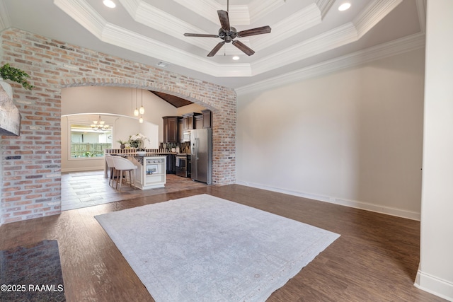 112 Heathwood Dr, Broussard, LA 70518 - living area with ceiling fan, a tray ceiling, crown molding, arched walkways, and dark wood-type flooring