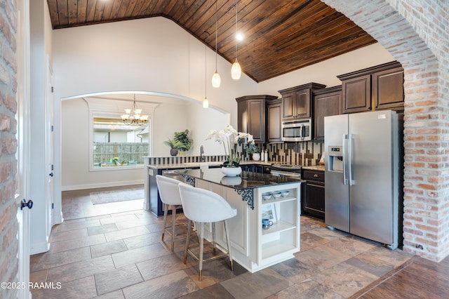 112 Heathwood Dr, Broussard, LA 70518 - kitchen featuring stainless steel appliances, wooden ceiling, dark brown cabinetry, arched walkways, and a chandelier