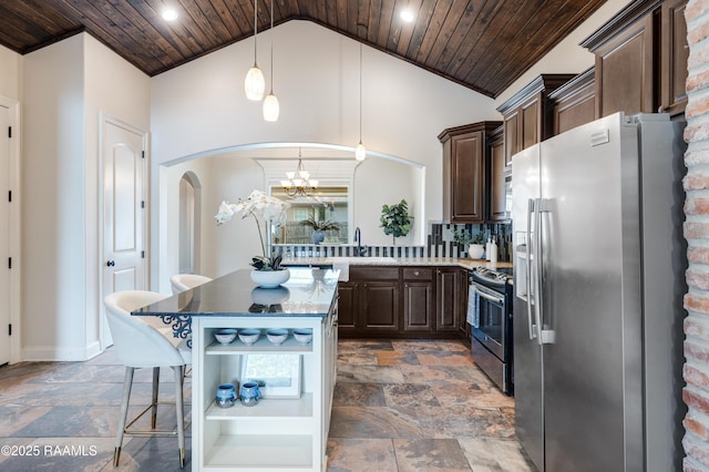112 Heathwood Dr, Broussard, LA 70518 - kitchen featuring stainless steel appliances, stone tile floors, arched walkways, wooden ceiling, and dark brown cabinetry