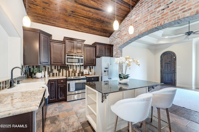 112 Heathwood Dr, Broussard, LA 70518 - kitchen with stainless steel appliances, a sink, dark brown cabinets, wooden ceiling, and arched walkways