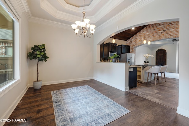 112 Heathwood Dr, Broussard, LA 70518 - kitchen with arched walkways, a chandelier, stainless steel fridge, a breakfast bar area, and vaulted ceiling