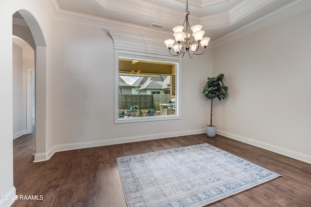 112 Heathwood Dr, Broussard, LA 70518 - unfurnished dining area featuring a chandelier, ornamental molding, wood finished floors, arched walkways, and a raised ceiling