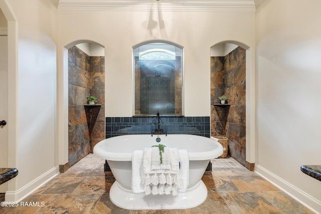 112 Heathwood Dr, Broussard, LA 70518 - full bathroom with stone tile flooring, tile walls, a soaking tub, baseboards, and ornamental molding