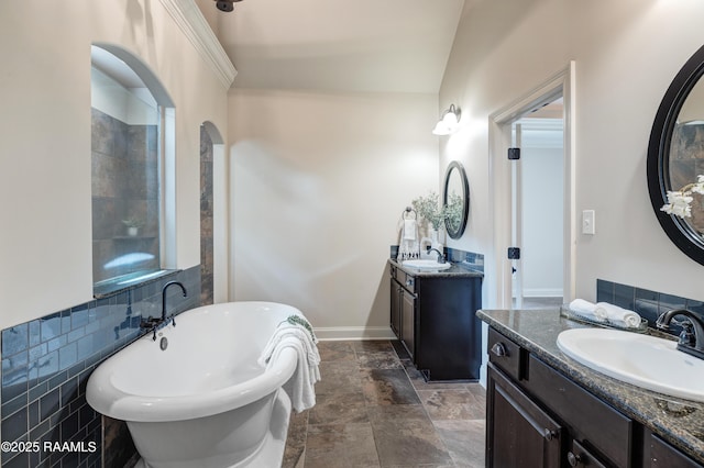 112 Heathwood Dr, Broussard, LA 70518 - full bathroom with a freestanding tub, two vanities, and stone finish flooring