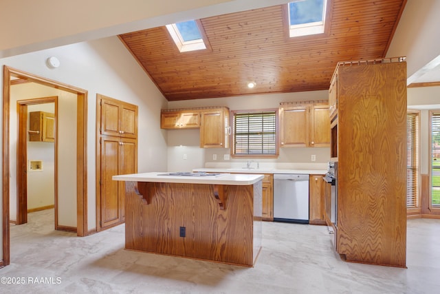 505 River Woods Dr, Lafayette, LA 70508 - kitchen featuring stainless steel dishwasher, a skylight, a kitchen island, lofted ceiling, and light countertops